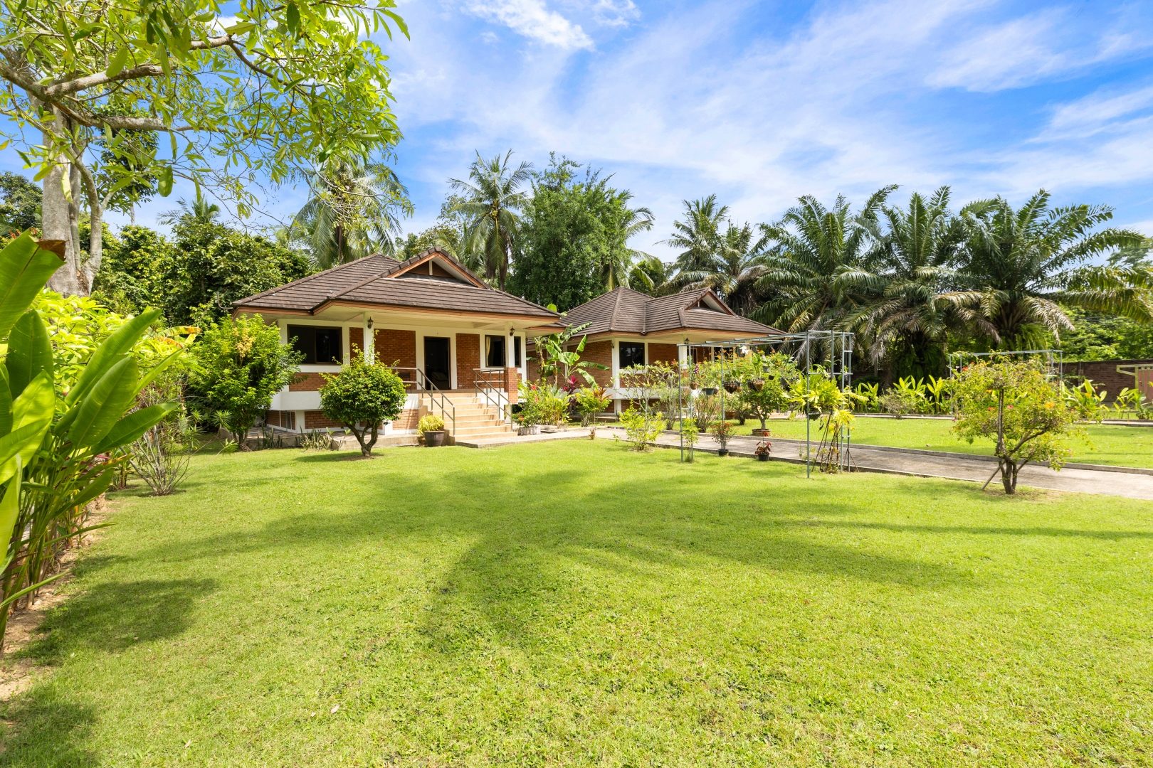 A row of thatched Thai villas on the ANODDA land