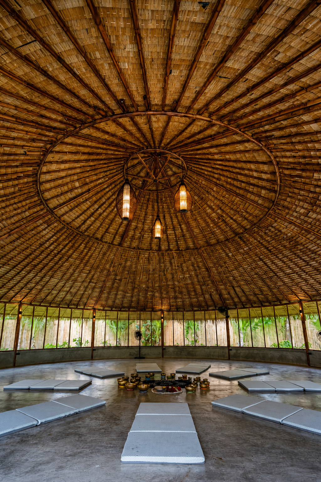 Shala interior — warm wood, natural light, open to the garden