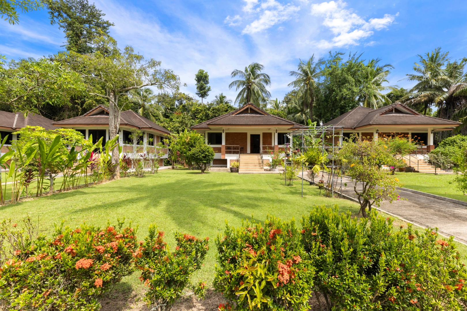 A row of traditional Thai villas set into the garden